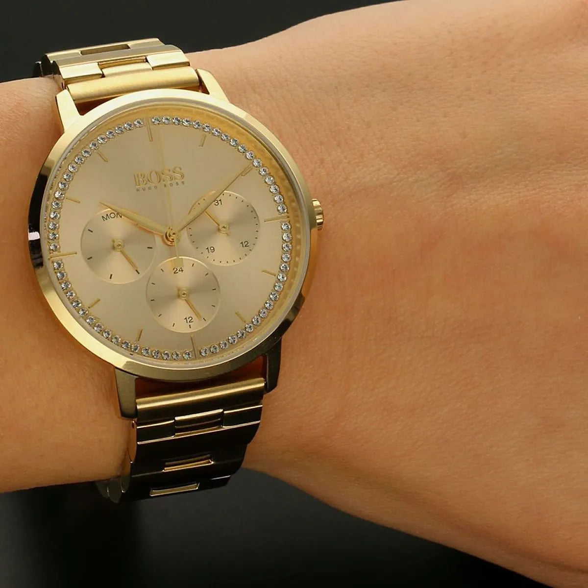 Hugo Boss Purity women's watch worn on wrist, displaying gold dial with crystal bezel and chronograph subdials
