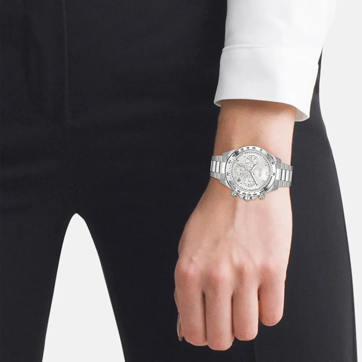 Hugo Boss silver chronograph watch worn on wrist with formal black and white attire