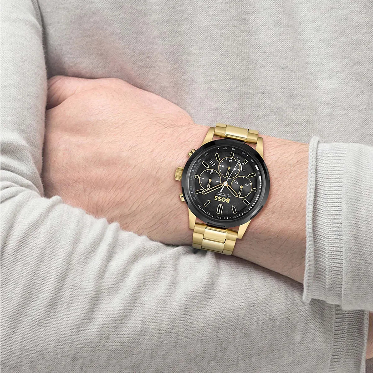 Hugo Boss Solgrade chronograph watch worn on wrist with gold bracelet and black dial