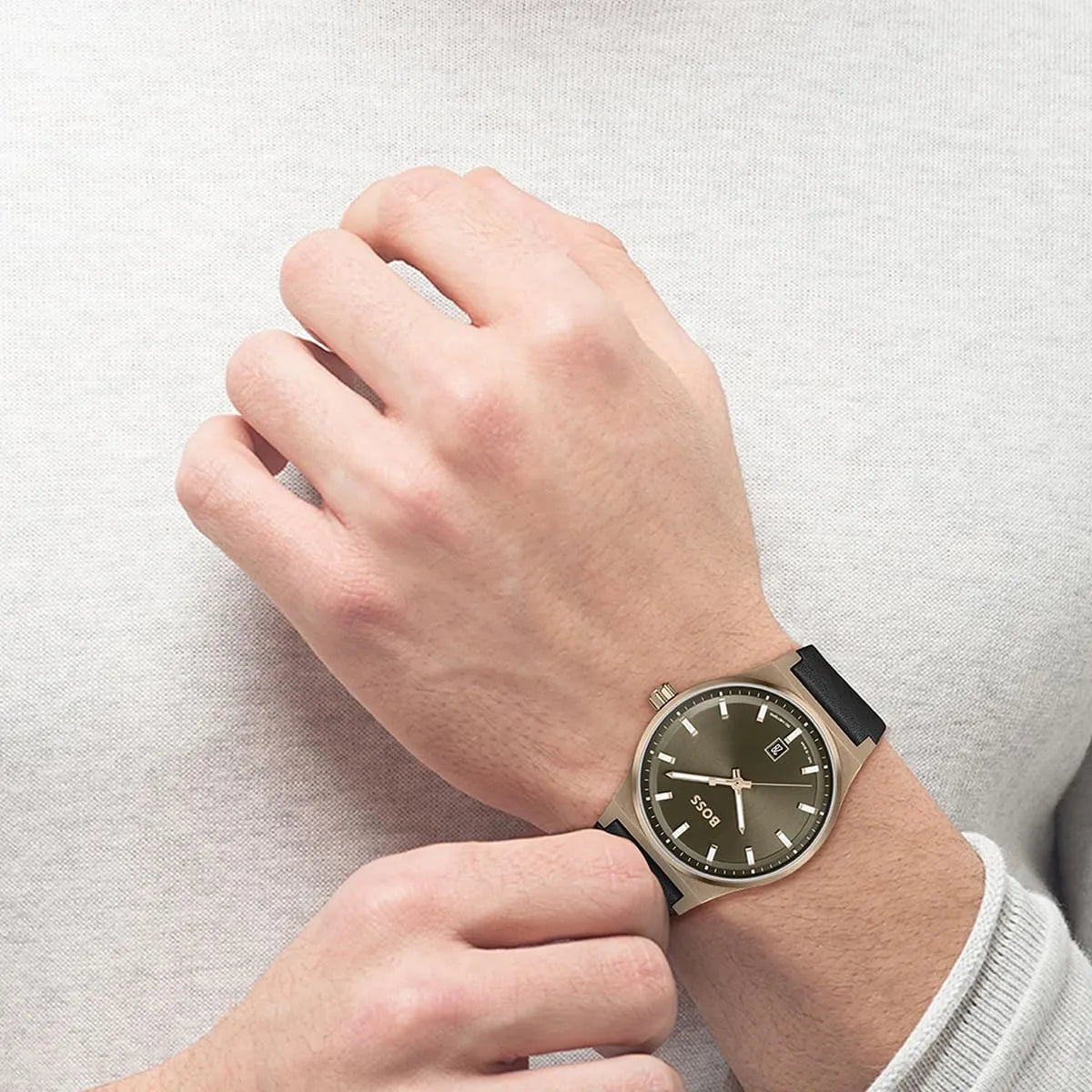 Hugo Boss Candor quartz watch worn on wrist showing olive green dial and black leather strap