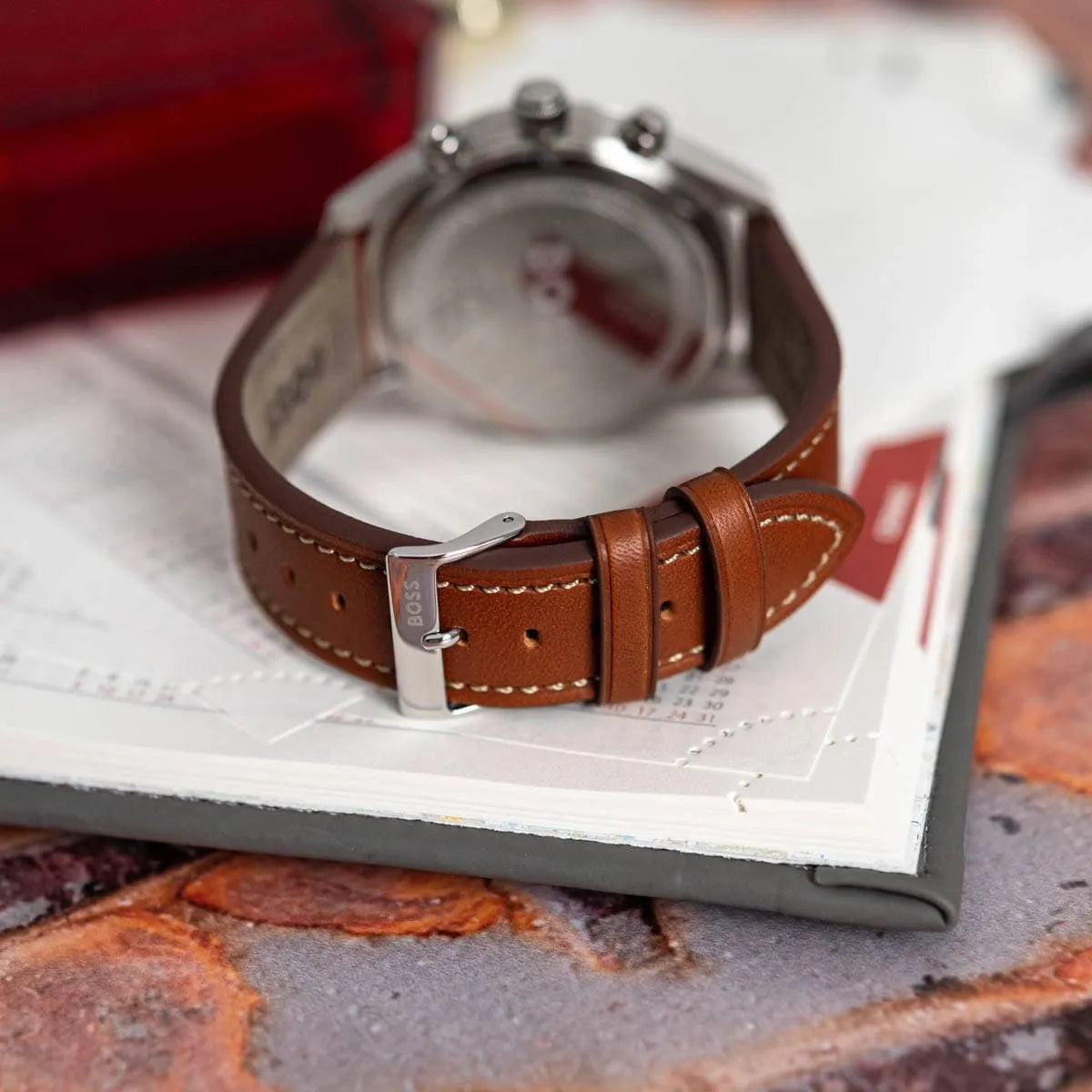 Hugo Boss Skytraveller chronograph watch with brown leather strap on desk