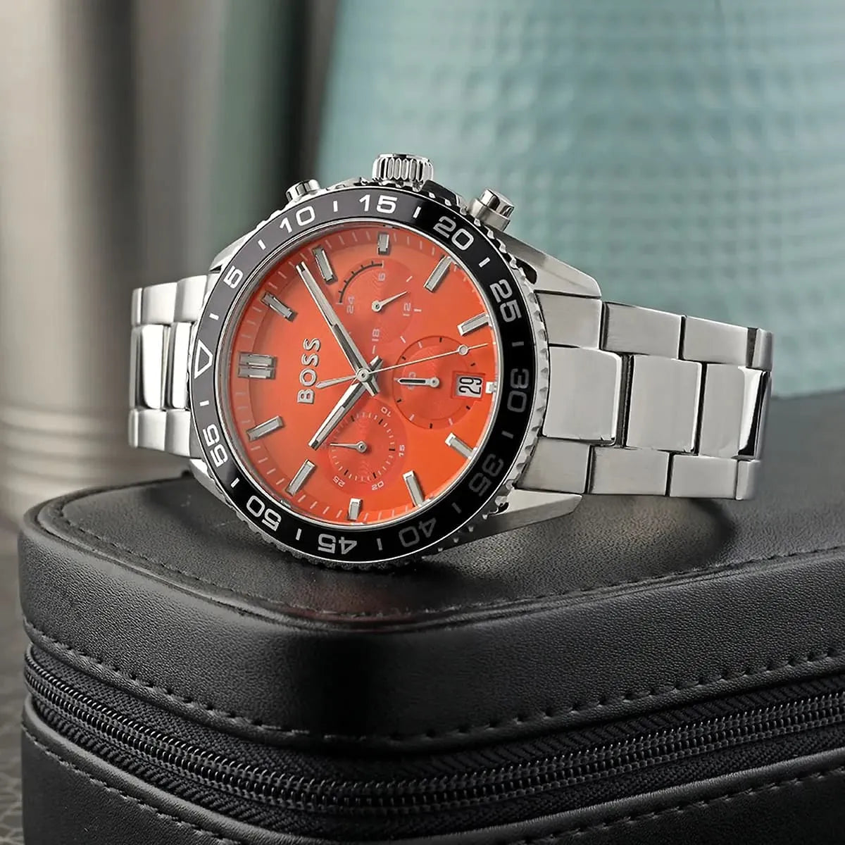 Hugo Boss Runner chronograph watch with orange dial on dark surface