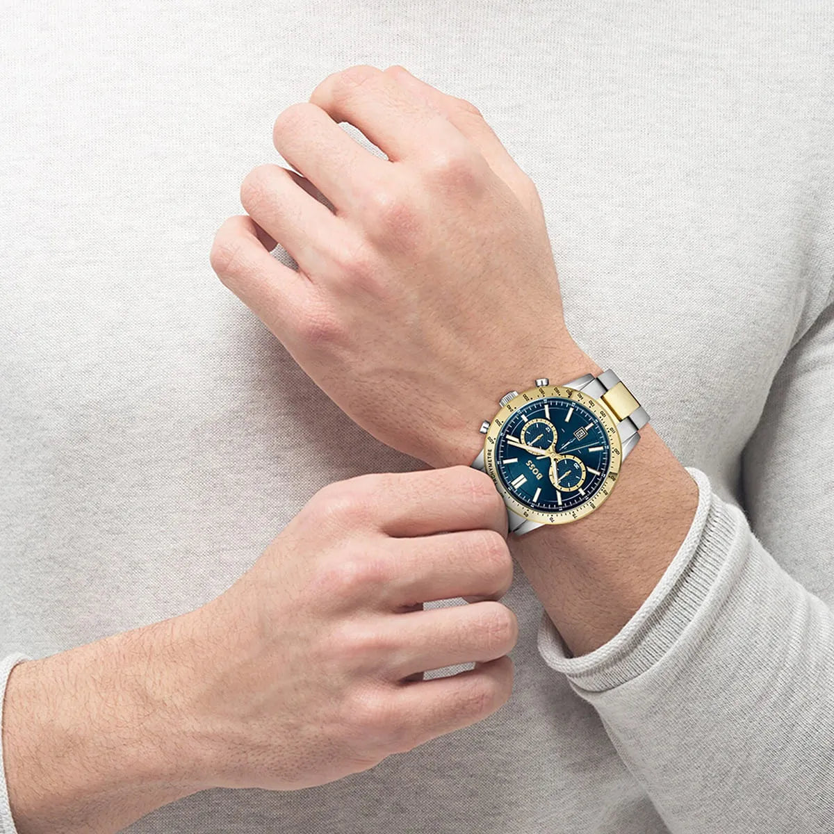 Hugo Boss Allure chronograph men's watch worn on wrist with blue dial and gold-silver stainless steel bracelet