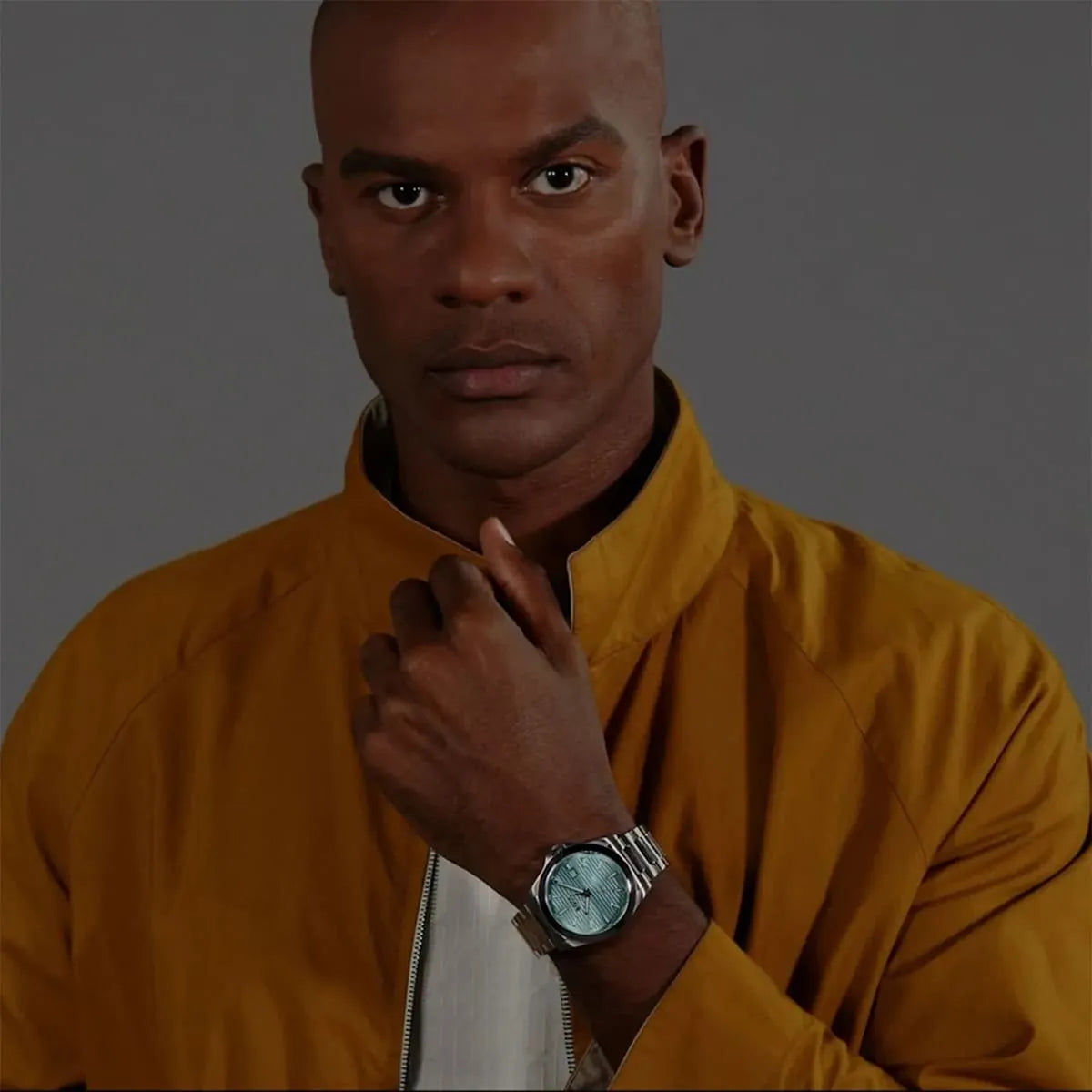 Hugo Boss Strike watch worn on wrist with turquoise dial in casual lifestyle setting