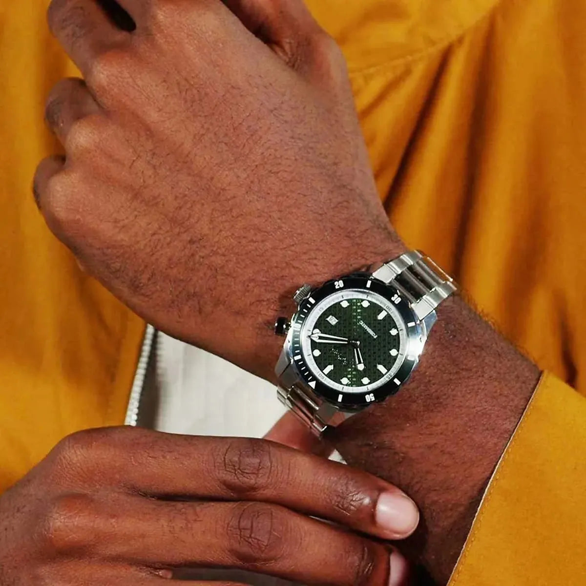 Hugo Boss Skymaster chronograph worn on wrist with green dial and stainless steel bracelet