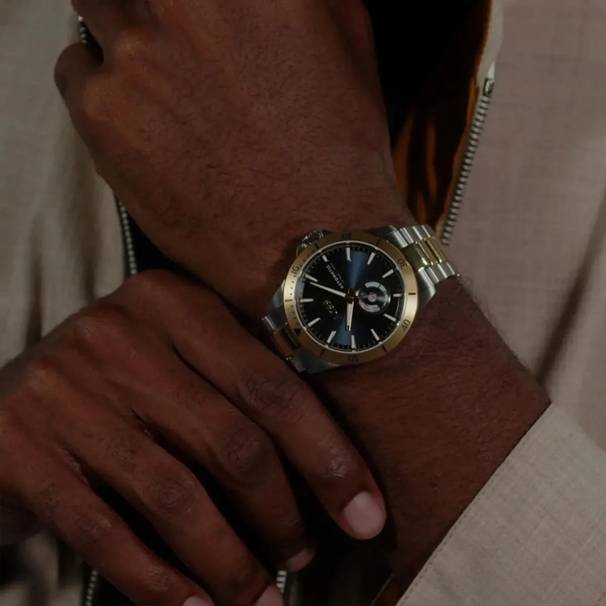 Hugo Boss Troper automatic watch on wrist displaying navy dial and two-tone metal bracelet