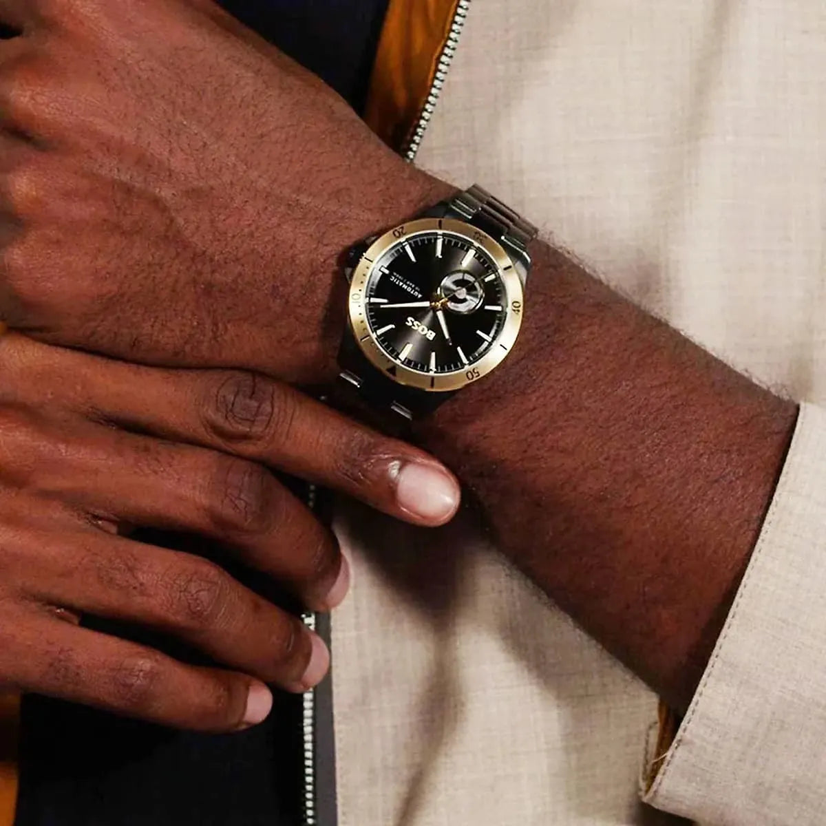 Hugo Boss Troper automatic watch worn on wrist with black dial and gold bezel