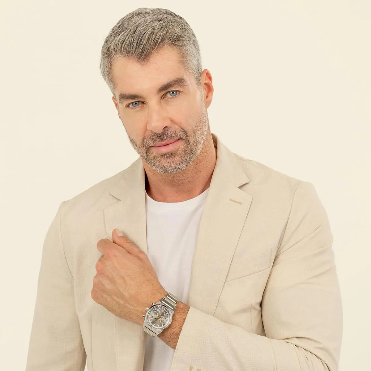 Man wearing Hugo Boss Candor chronograph watch with cream-colored blazer