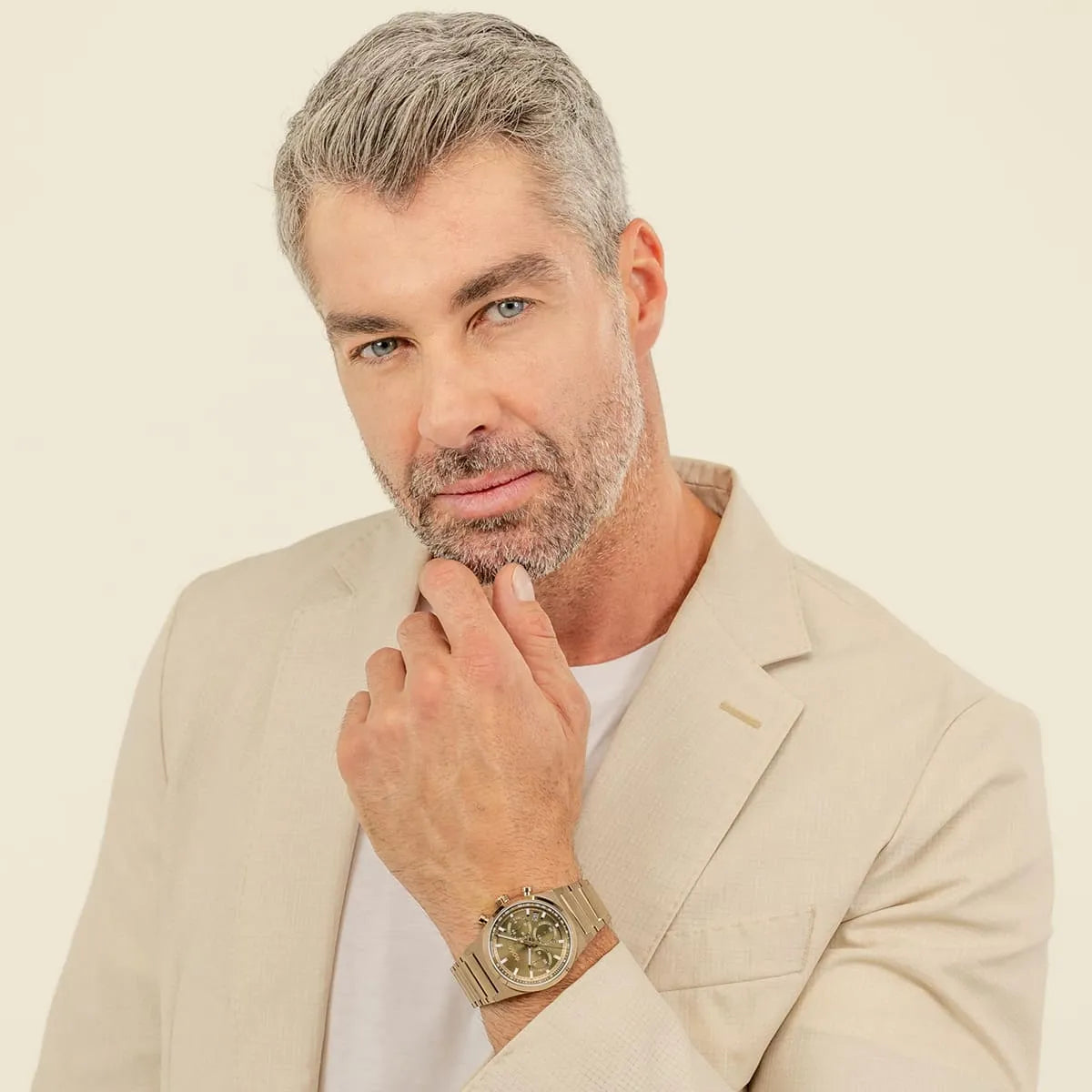 Man wearing Hugo Boss Candor watch with green dial and stainless steel bracelet