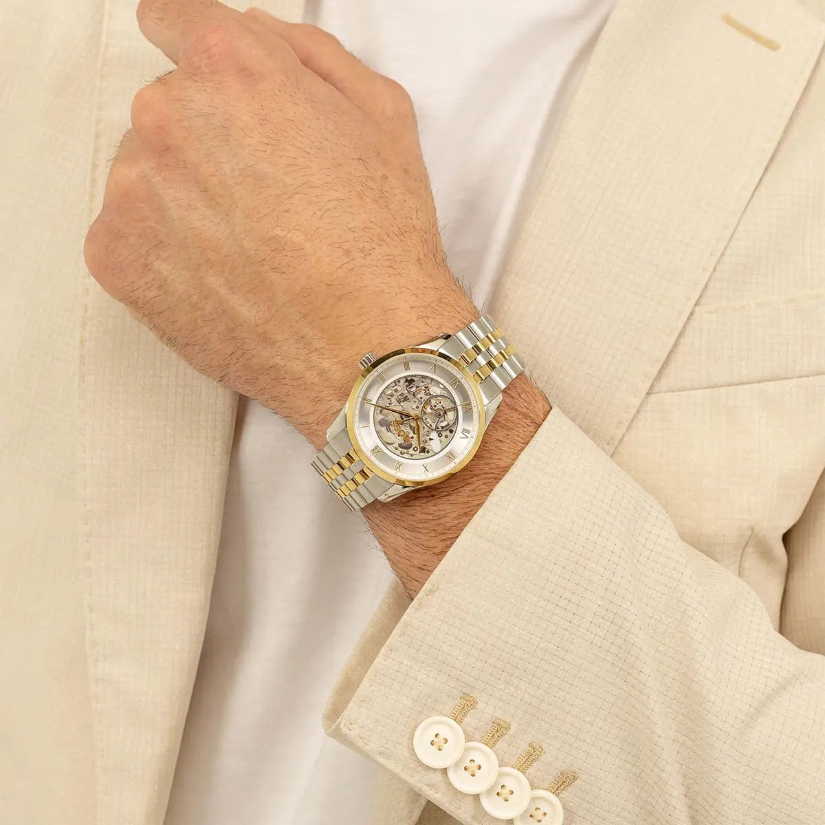 Hugo Boss Principle skeleton watch worn on wrist with two-tone strap
