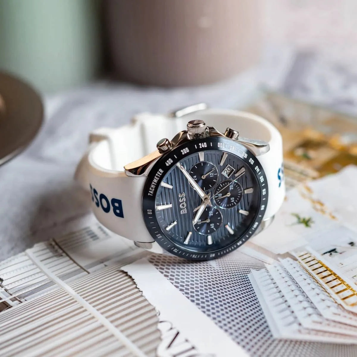 Hugo BOSS STRIKE chronograph watch with grooved blue dial and white strap lifestyle shot