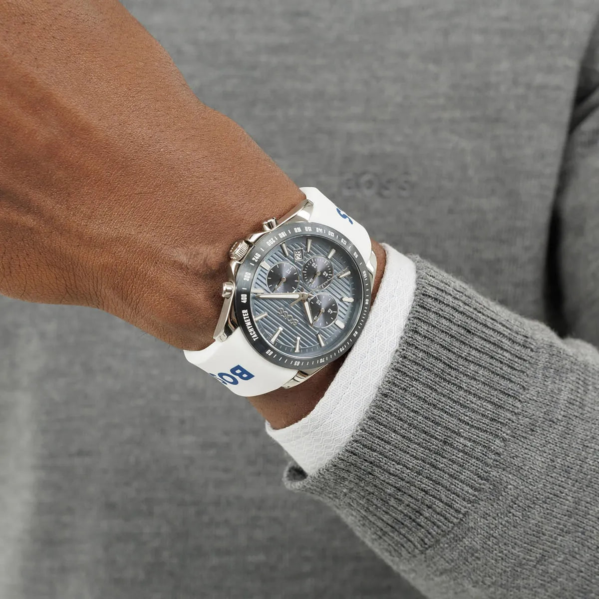 Hugo BOSS STRIKE chronograph watch on wrist displaying grooved dial and white rubber strap