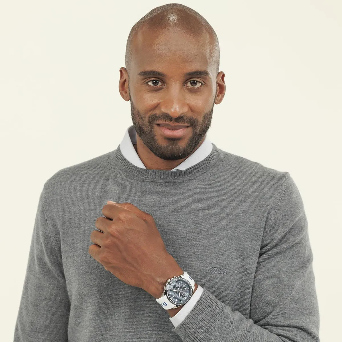 Man wearing Hugo BOSS STRIKE watch with grooved blue dial and white strap on wrist