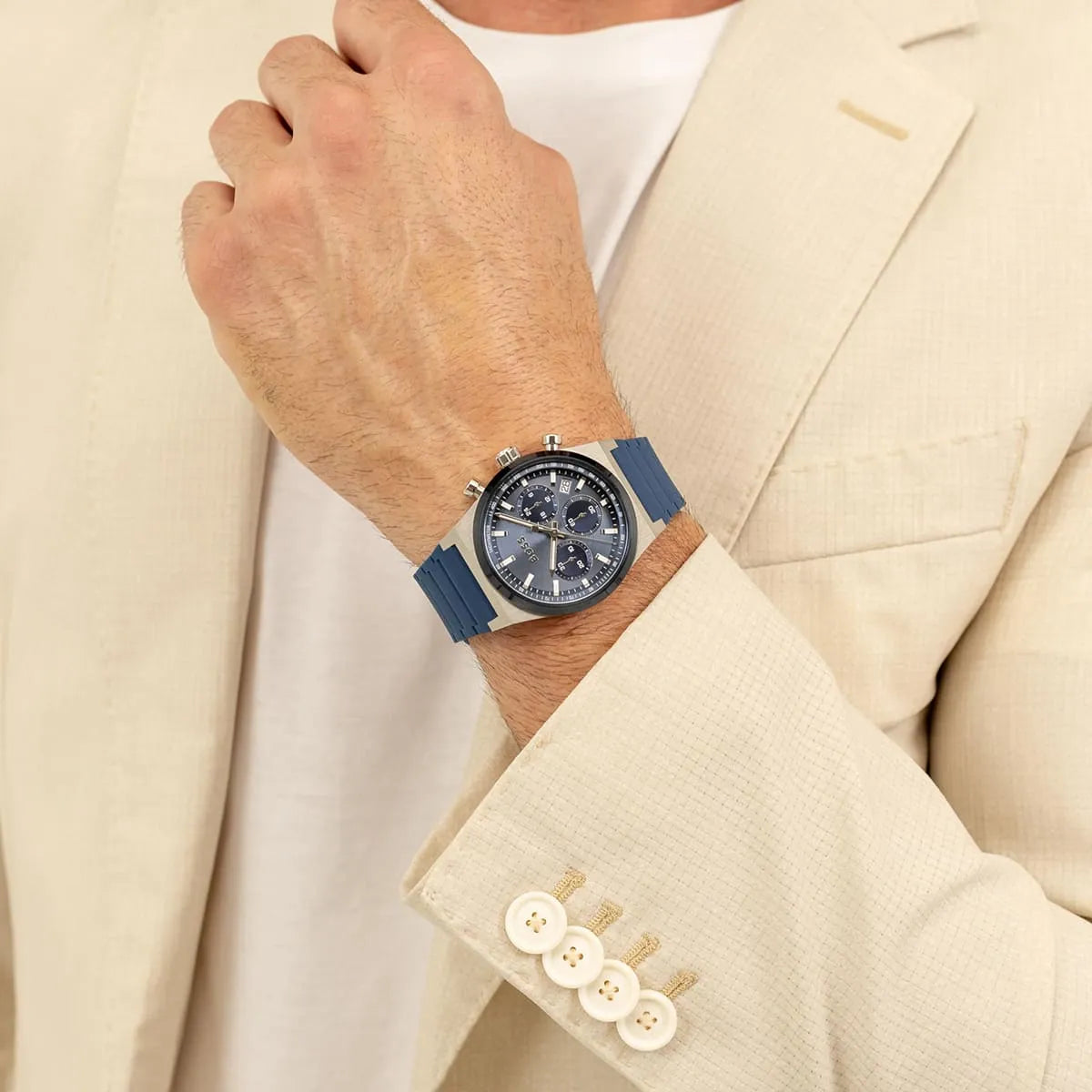 Hugo Boss Candor chronograph watch worn on wrist with blue dial and rubber strap