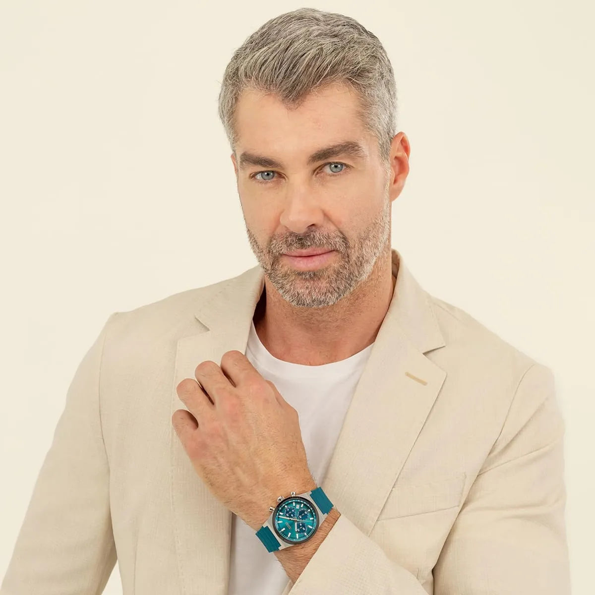 Man wearing Hugo Boss green chronograph watch with beige blazer