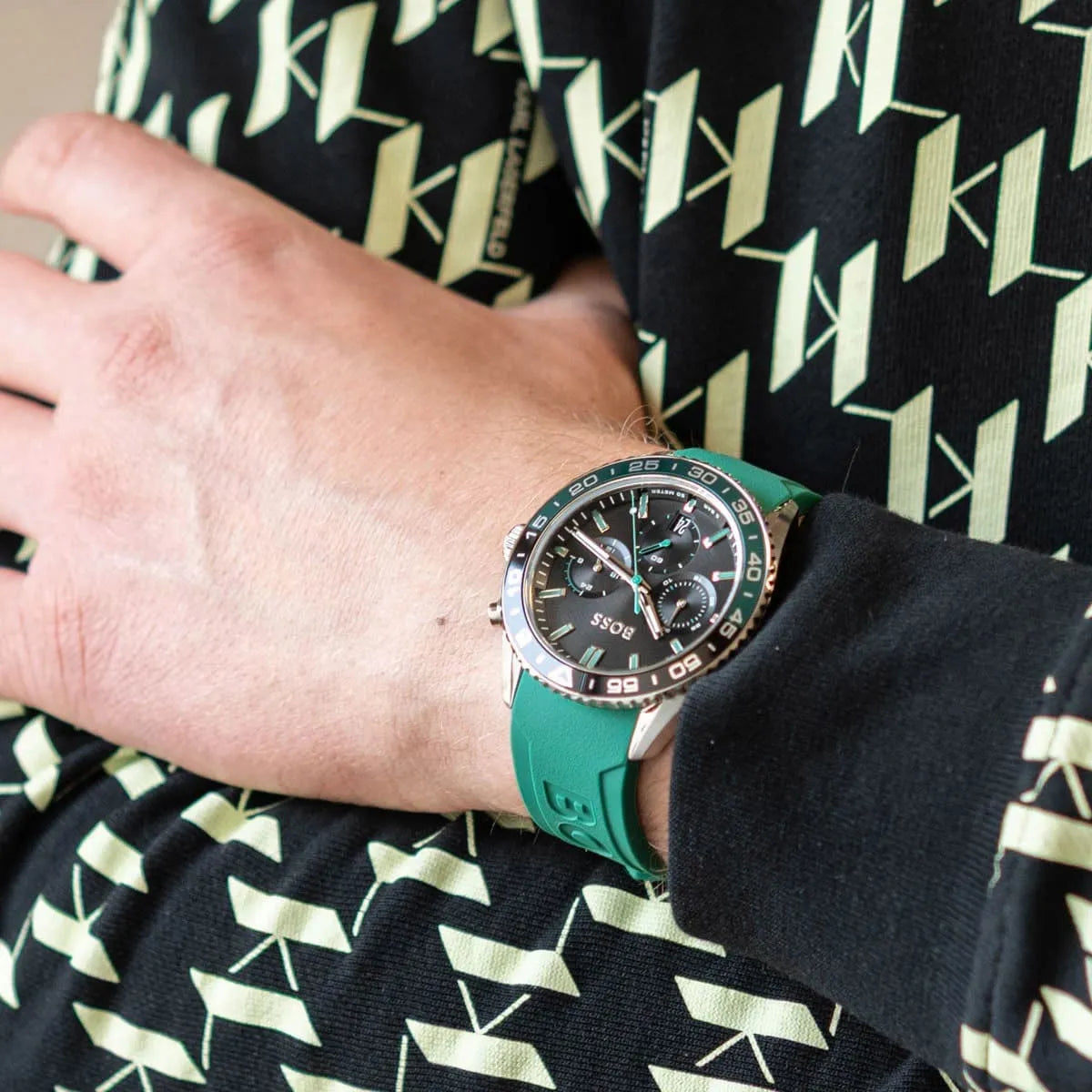 Hugo Boss PIONEER chronograph watch worn on wrist showing black dial and green rubber strap