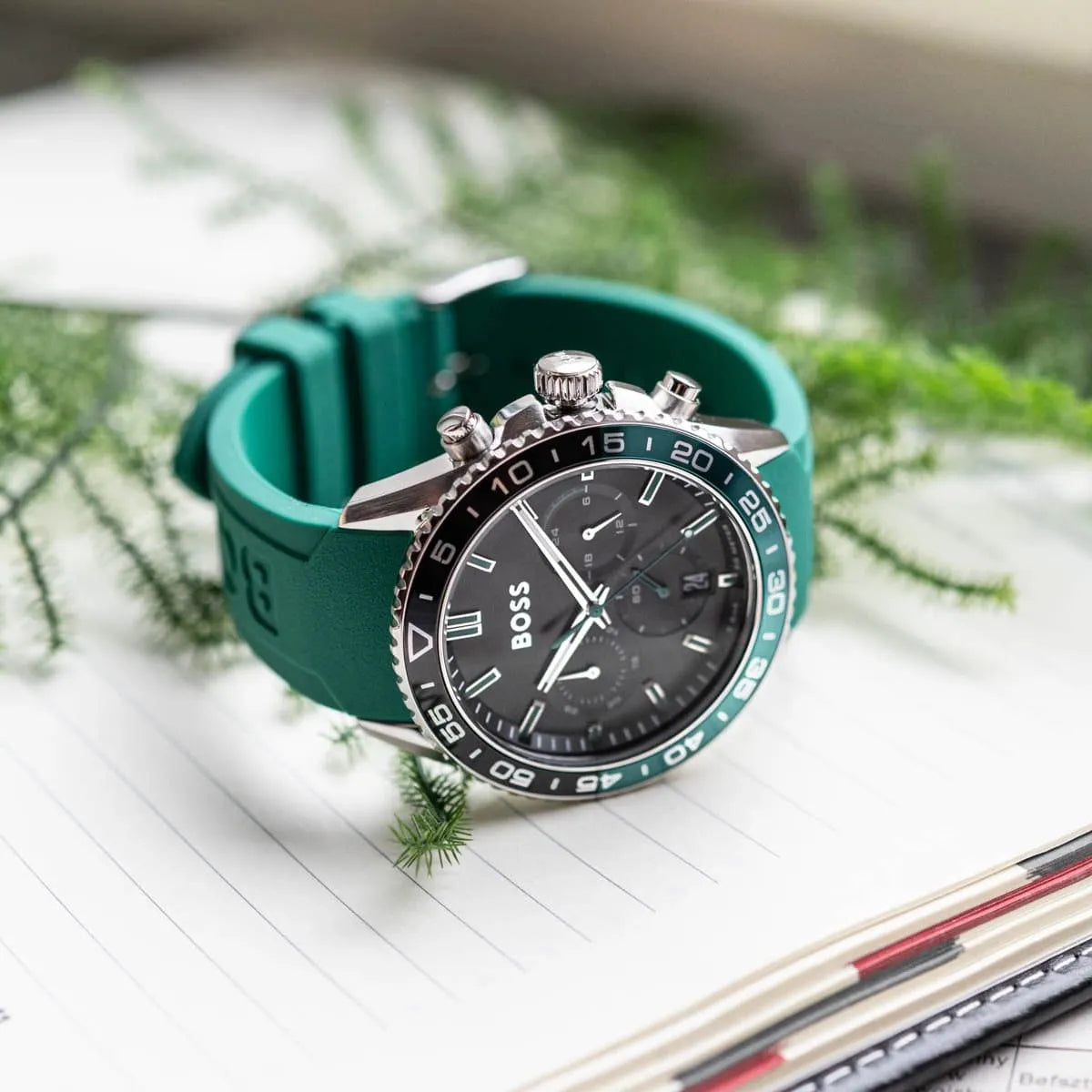 Hugo Boss PIONEER chronograph watch worn on wrist with green rubber strap