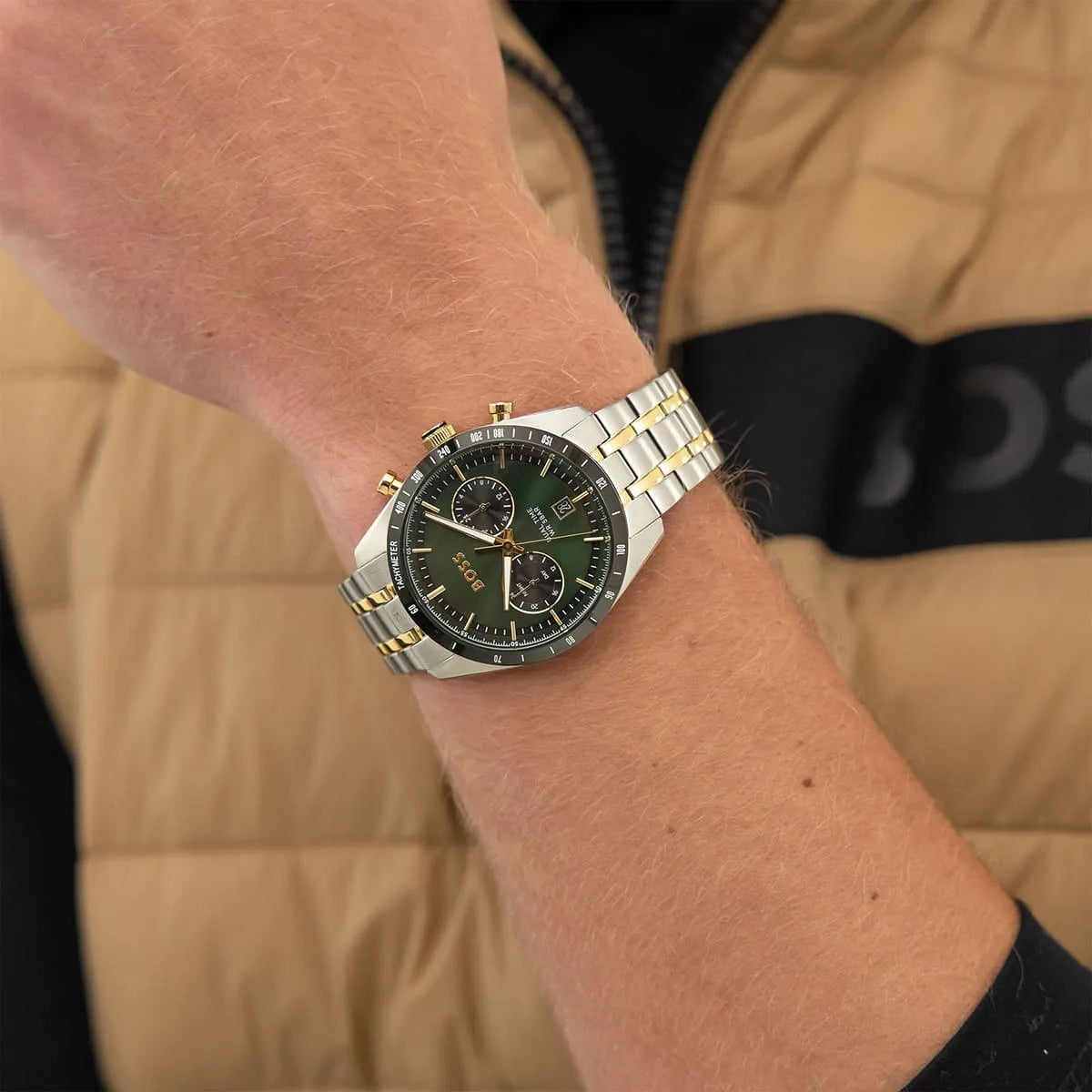 Hugo Boss Tourmaster green dial chronograph watch worn on wrist with two-tone bracelet