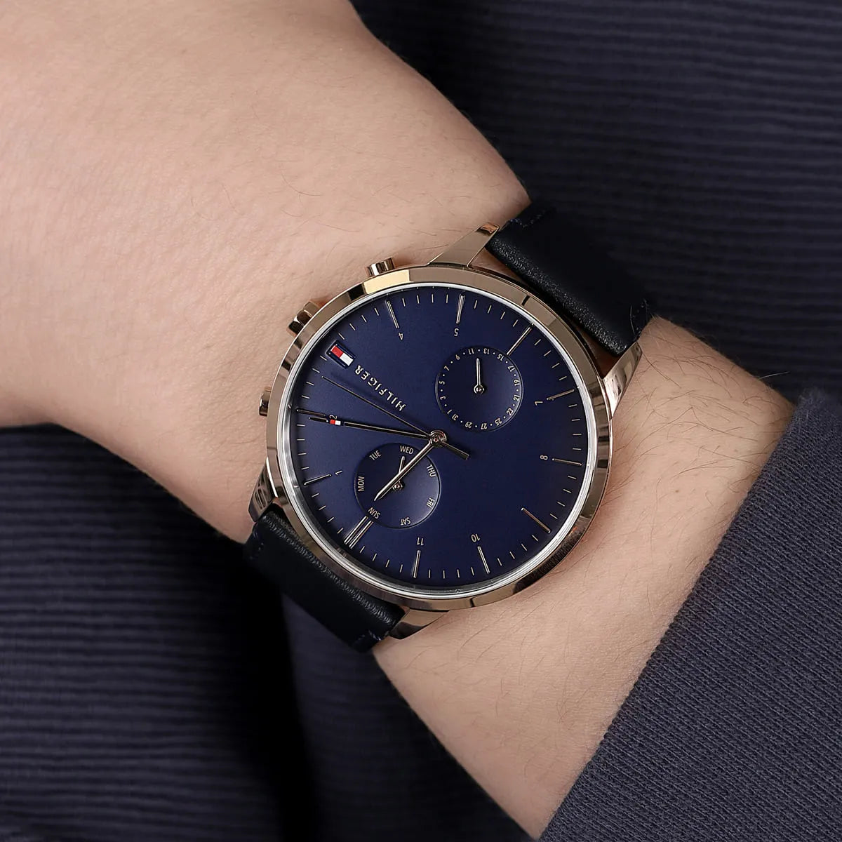 Tommy Hilfiger Hunter watch on wrist paired with dark blue dress shirt sleeve