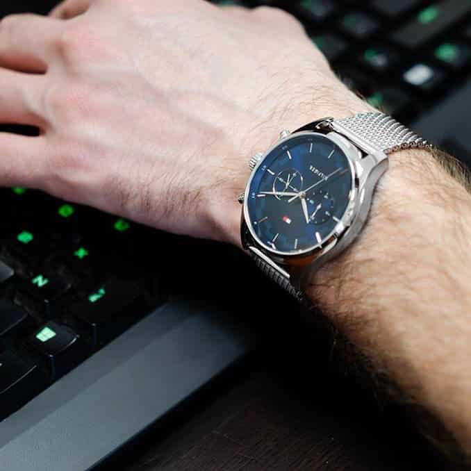 Tommy Hilfiger steel mesh watch worn on wrist showing blue dial and chronograph