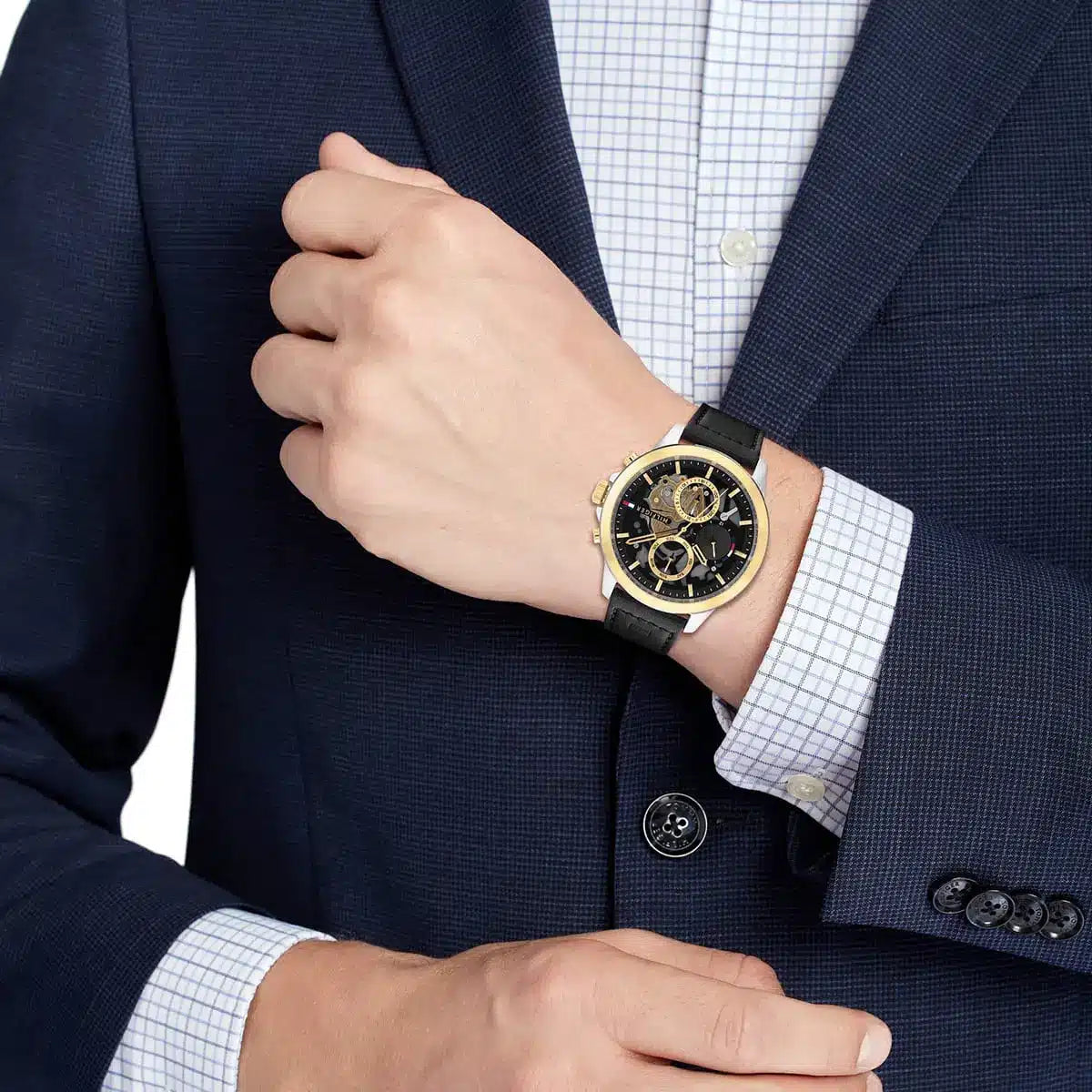 Tommy Hilfiger Henry watch worn on wrist with navy suit jacket