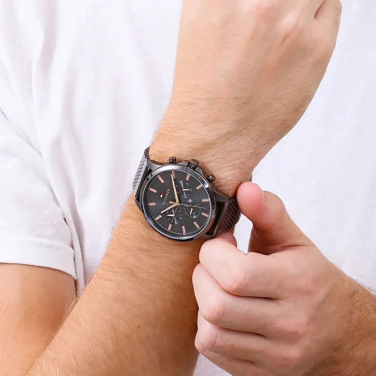 Tommy Hilfiger Ryder chronograph watch worn on wrist with gunmetal dial and mesh bracelet