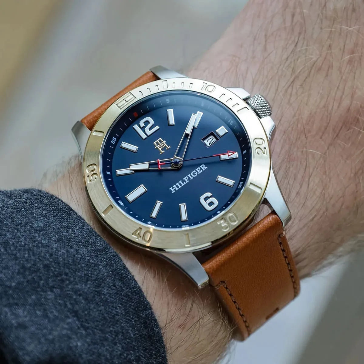 Ryan watch worn on wrist showing blue dial and gold bezel against skin