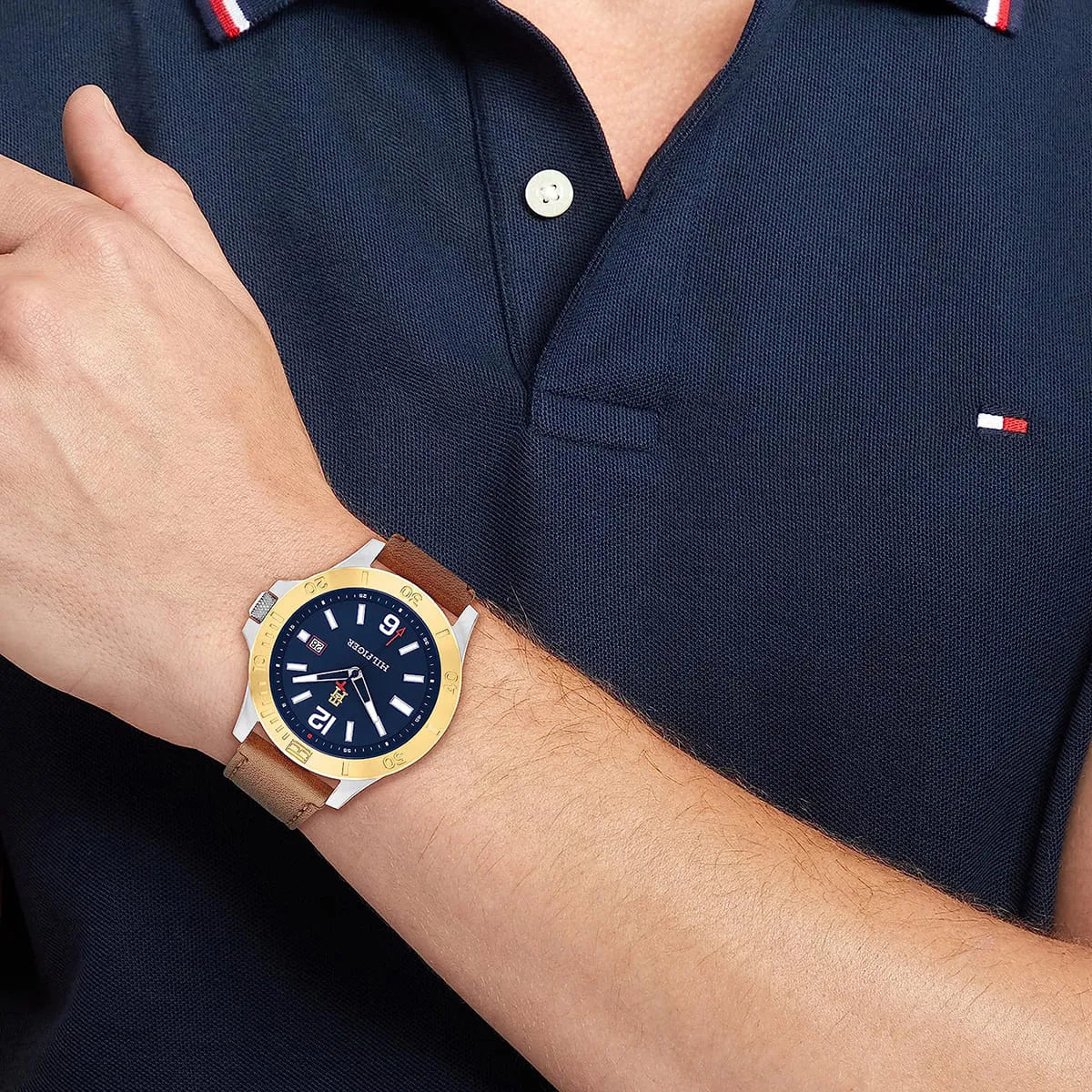Ryan watch on wrist paired with navy Tommy Hilfiger polo shirt
