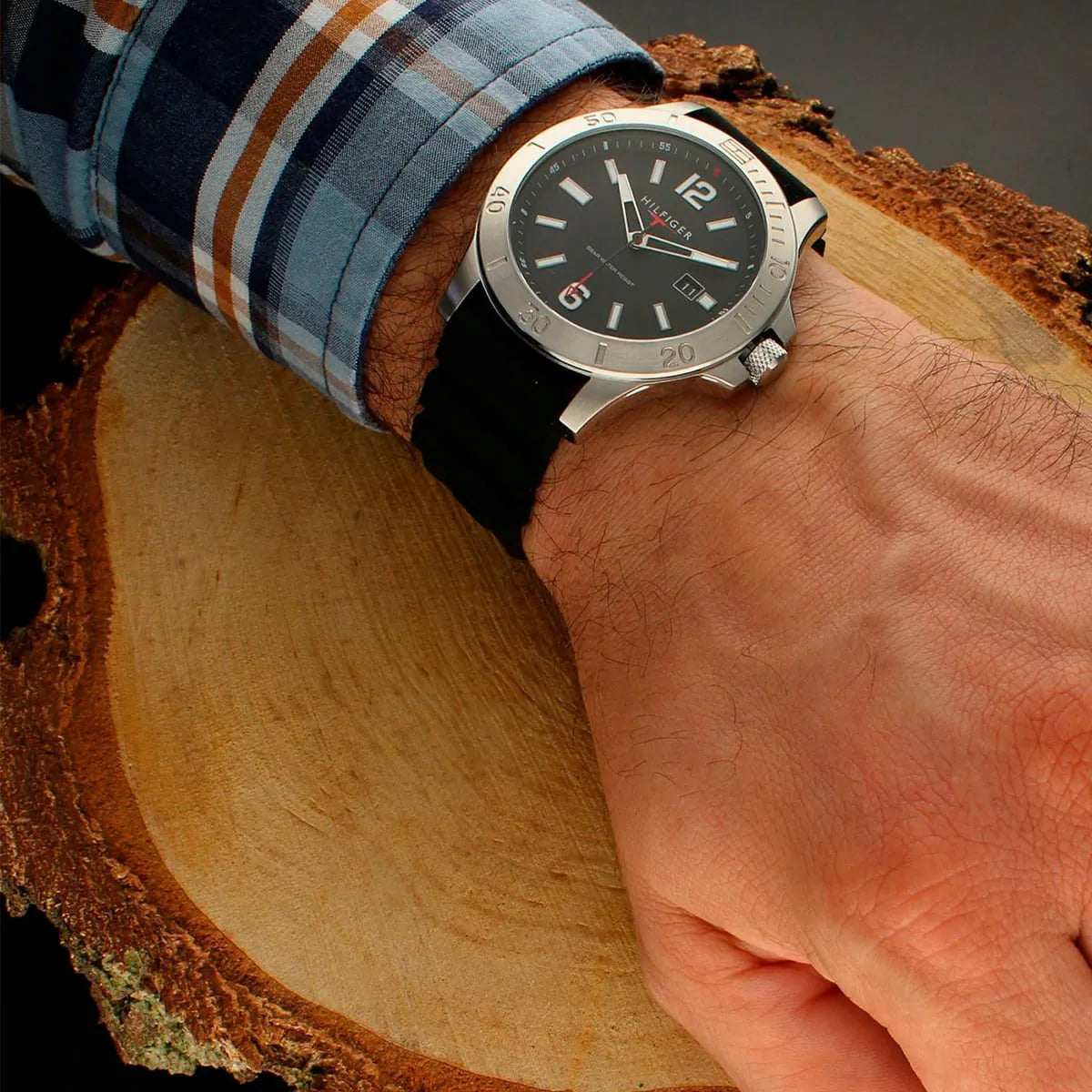 Tommy Hilfiger Ryan watch worn on wrist with plaid shirt and wooden background