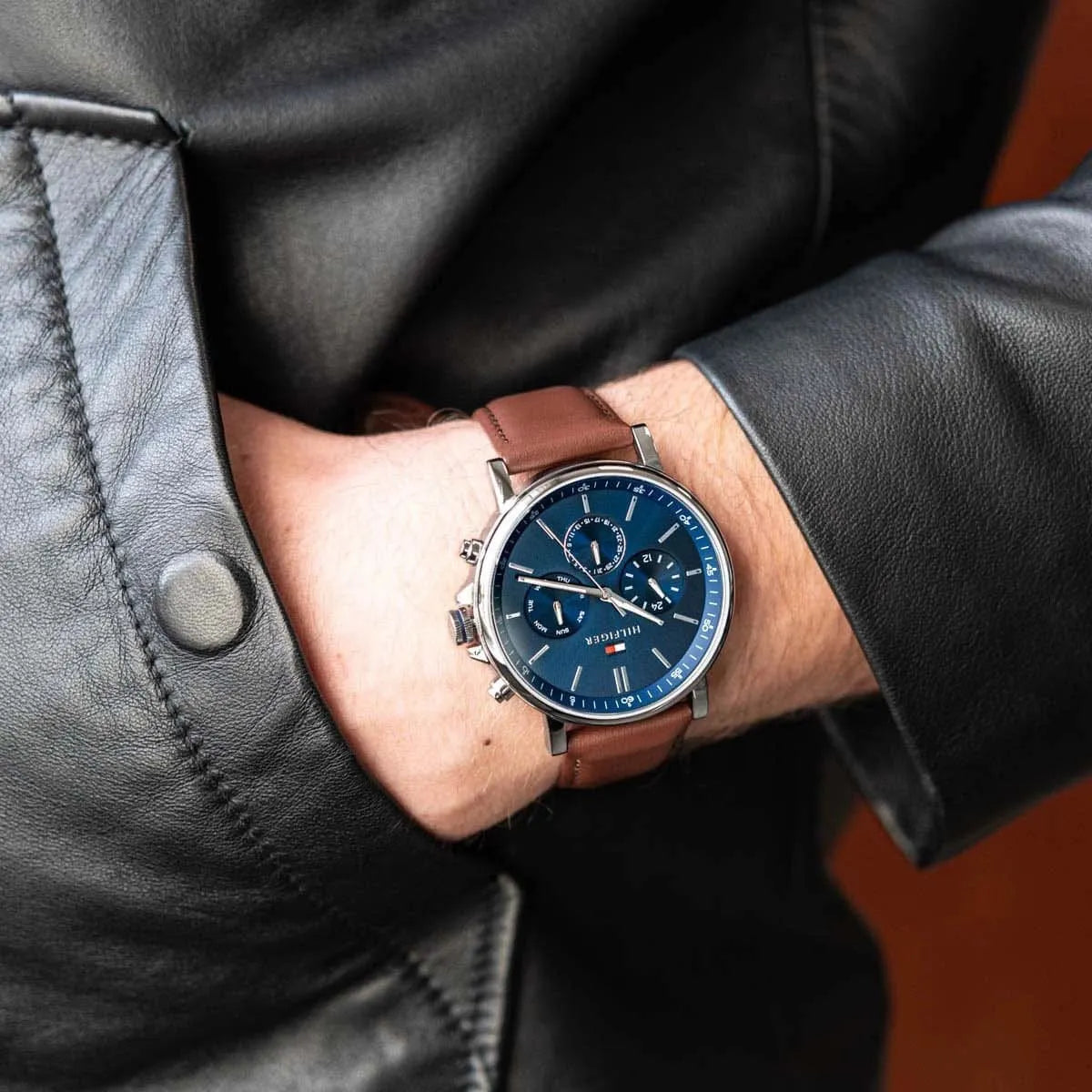 Tommy Hilfiger Tyson watch worn on wrist over dark clothing