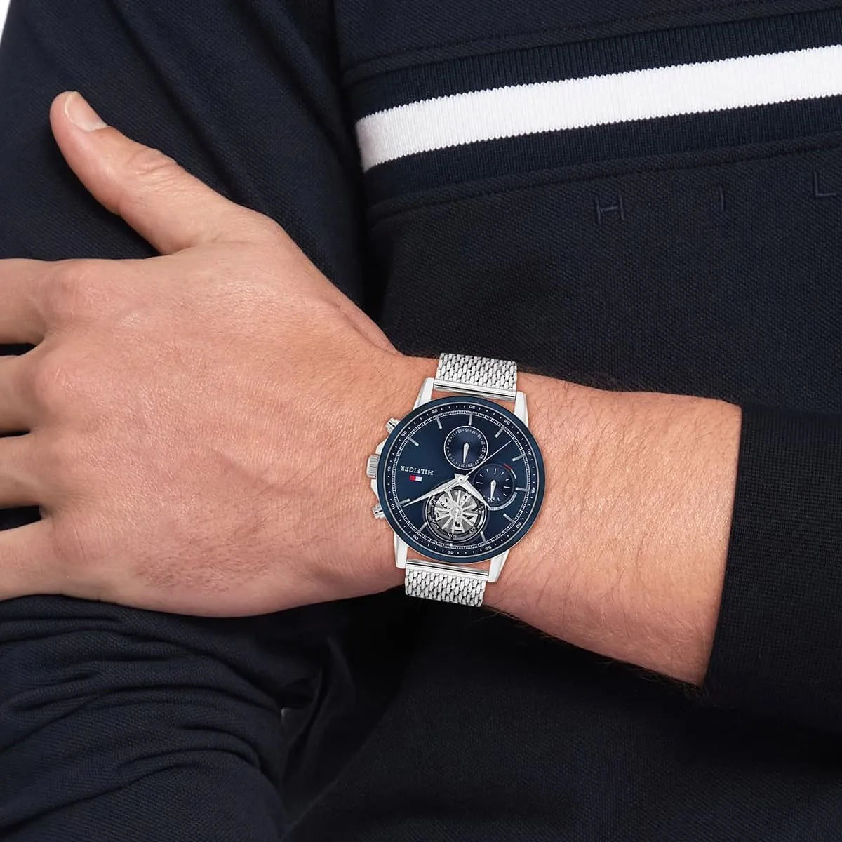 Tommy Hilfiger men's chronograph watch on wrist showing navy dial and chronograph subdials