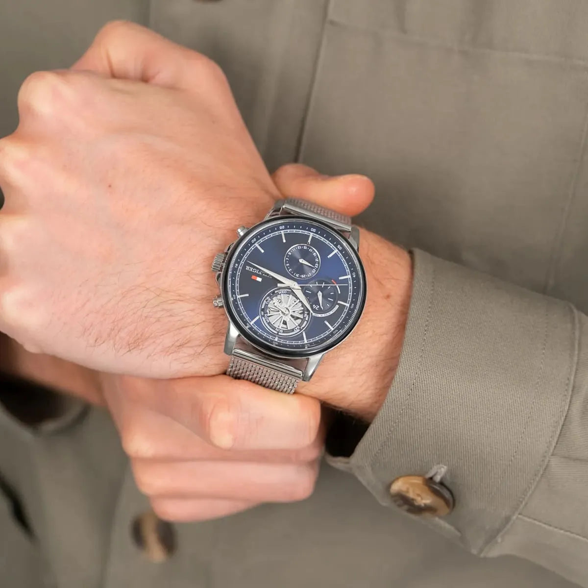 Tommy Hilfiger navy dial chronograph watch worn on wrist with silver mesh band