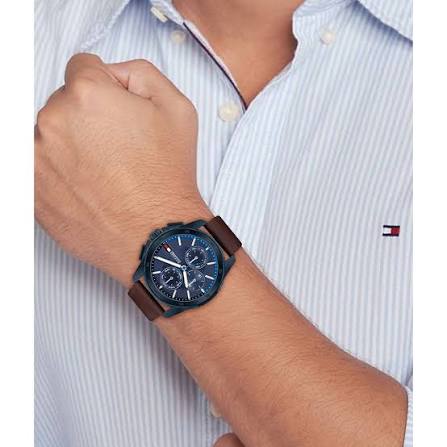 Tommy Hilfiger chronograph watch worn on wrist with striped blue shirt