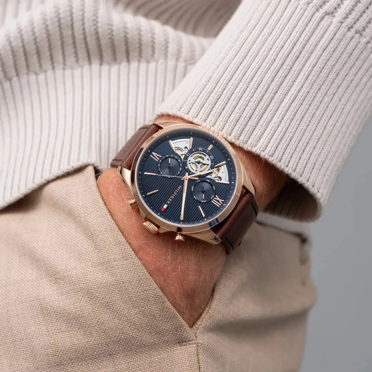 Tommy Hilfiger Baker watch worn on wrist with blue dial and brown leather strap visible