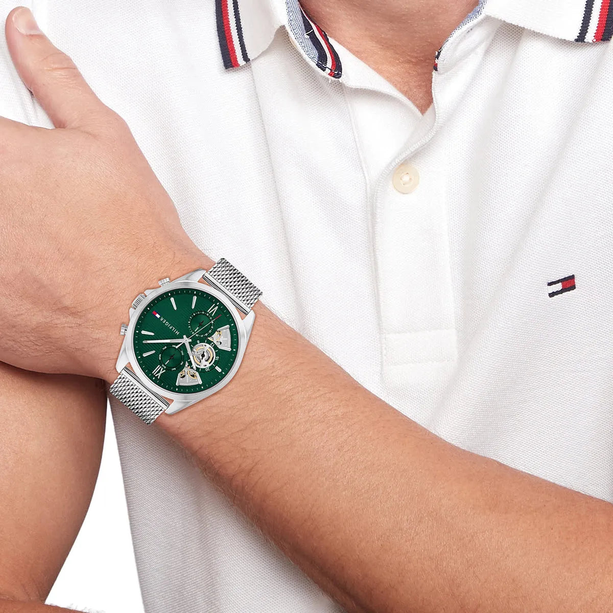 Tommy Hilfiger Baker watch worn on wrist with green dial and silver mesh strap
