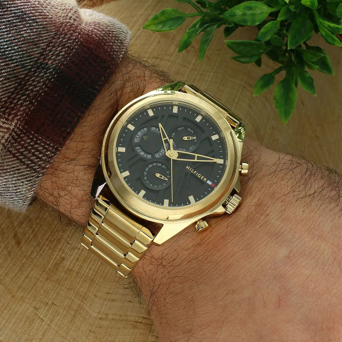 Overhead view of Tommy Hilfiger JAX watch on wrist with black dial and gold case