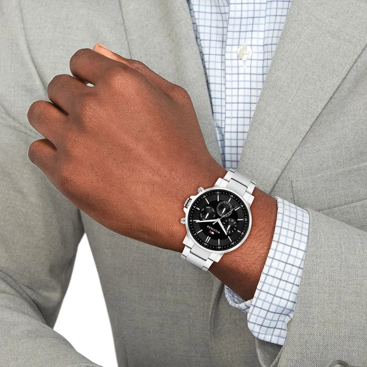 Tommy Hilfiger Tyson watch worn on wrist with black dial and silver stainless steel bracelet