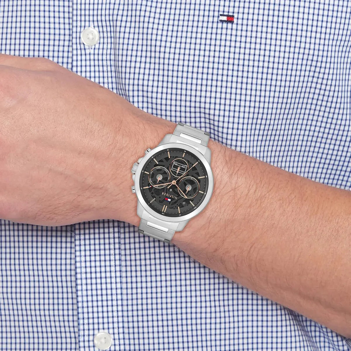 Tommy Hilfiger Henry chronograph watch on male wrist with blue and white checkered shirt