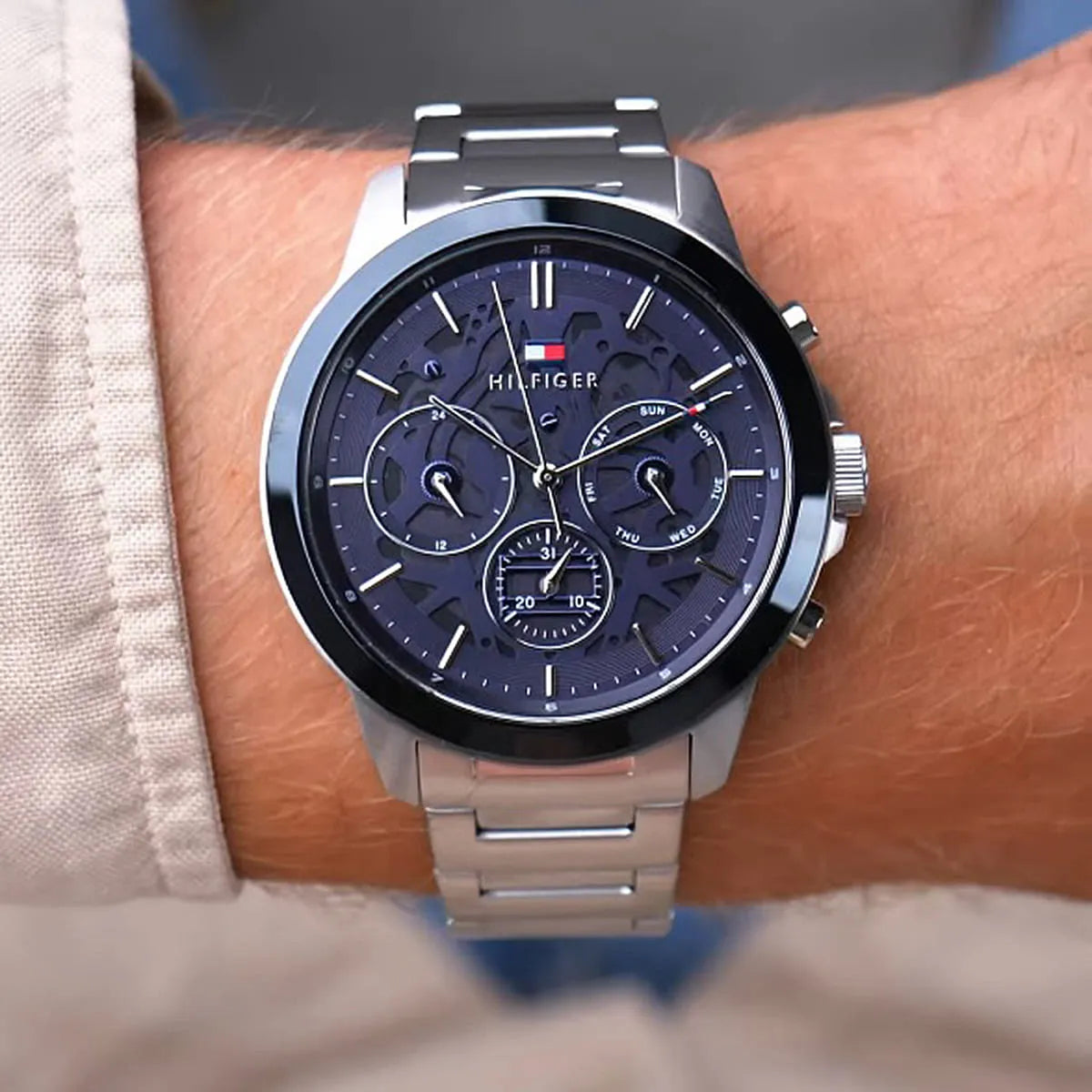 Tommy Hilfiger Henry watch worn on wrist with navy multi-function dial and metal strap