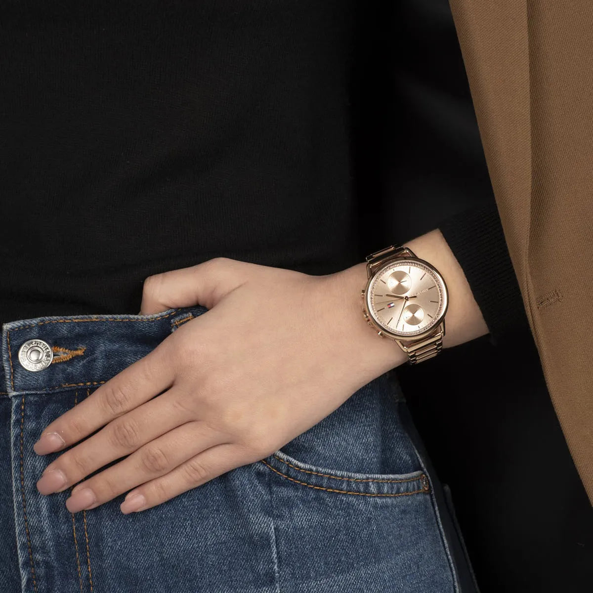 Tommy Hilfiger rose gold women's watch worn on wrist with rose gold metal band