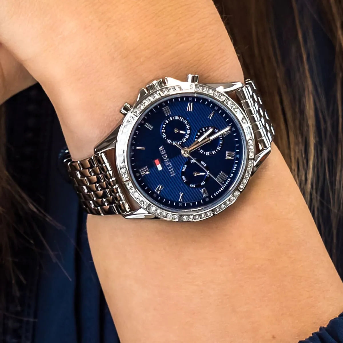 Tommy Hilfiger women's blue dial chronograph watch worn on wrist with crystal bezel