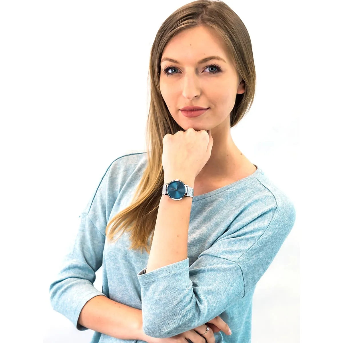Woman wearing Tommy Hilfiger Pippa watch with blue dial and stainless steel mesh bracelet