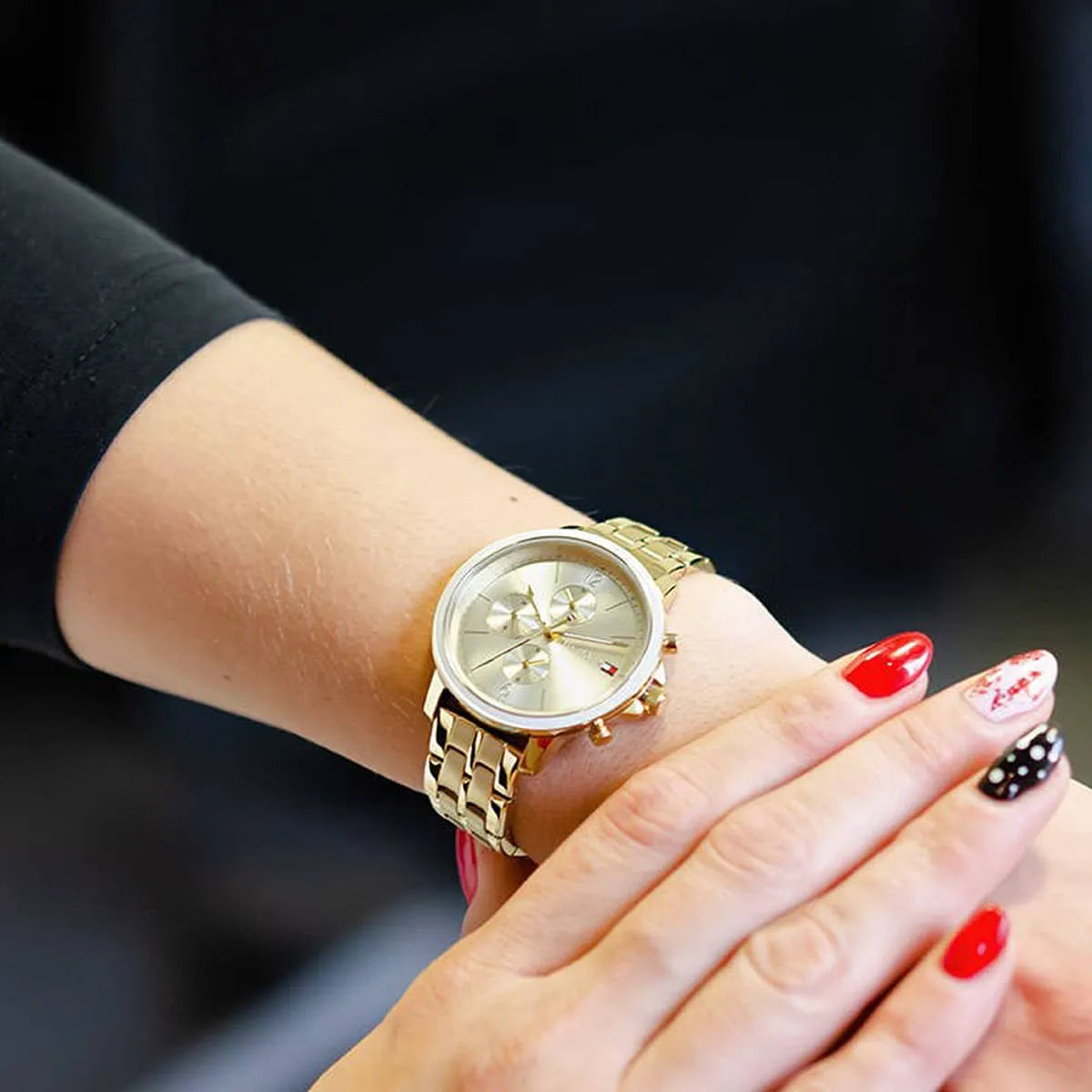 Tommy Hilfiger Madison gold watch worn on wrist with gold stainless steel bracelet