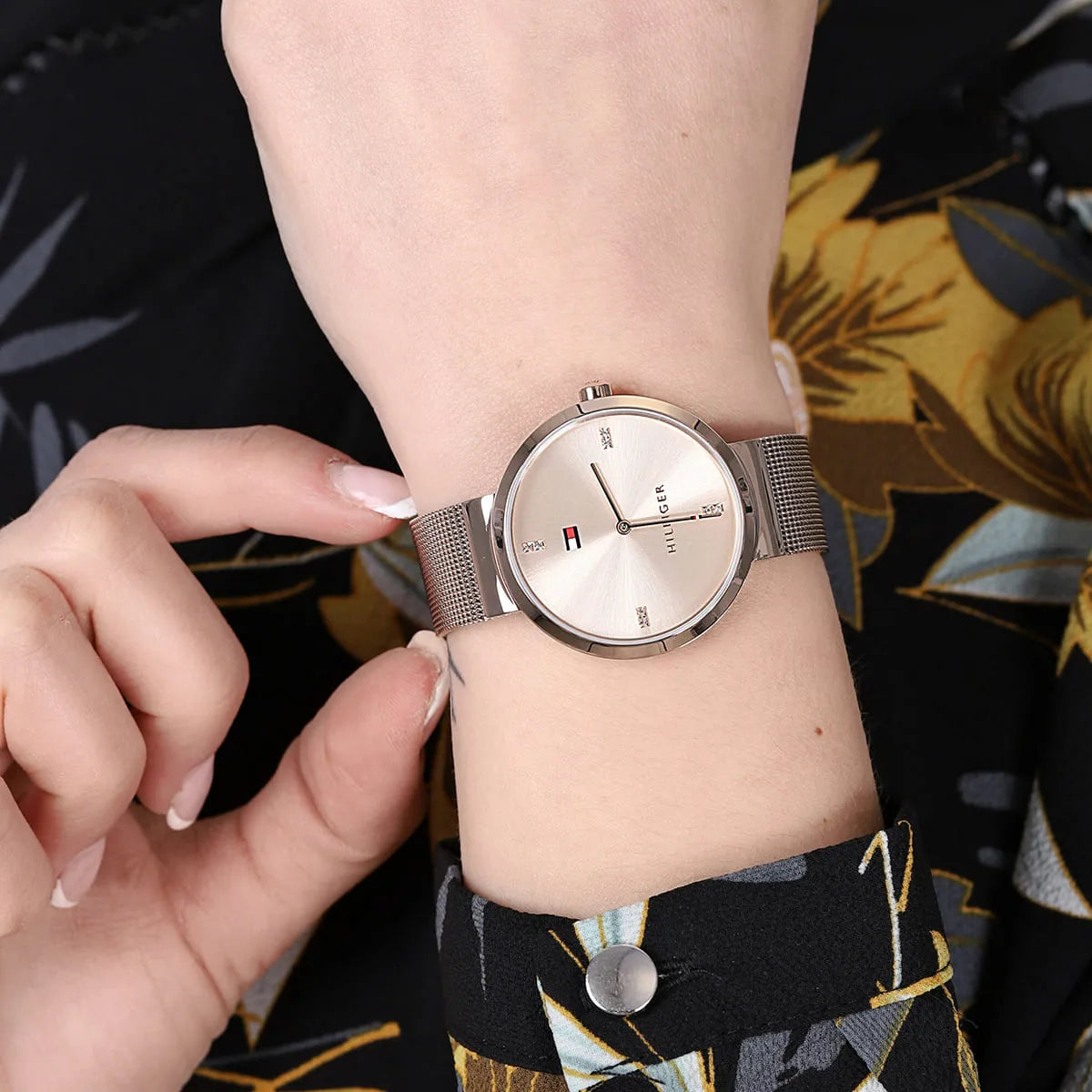 Tommy Hilfiger rose gold mesh watch worn on wrist