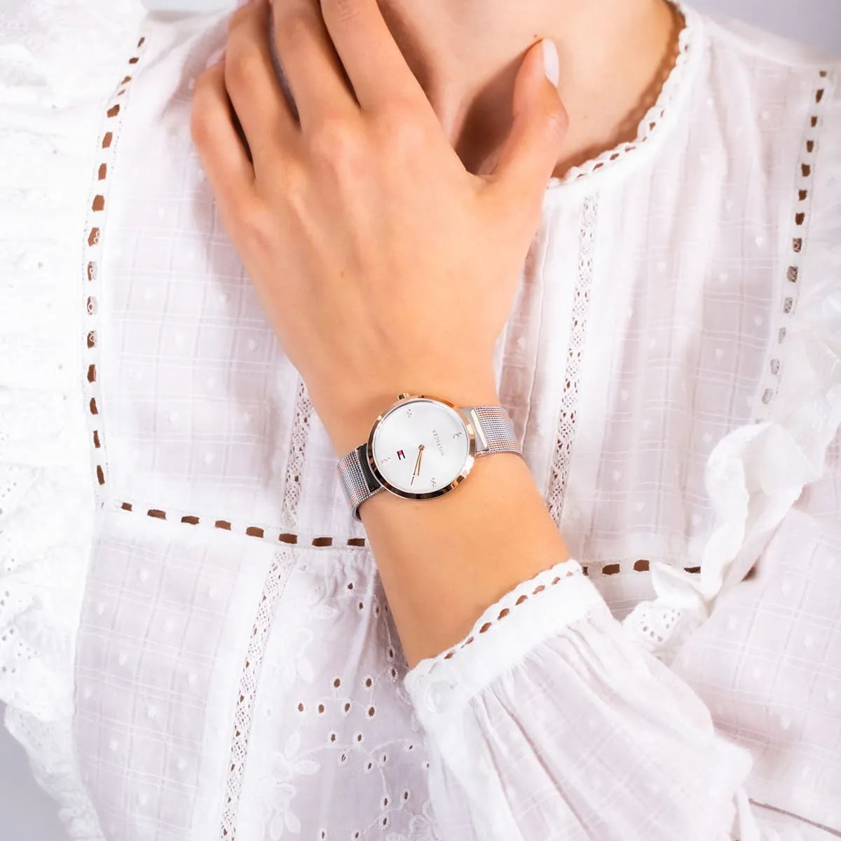 Tommy Hilfiger Liberty watch on wrist with two-tone mesh strap and minimalist dial