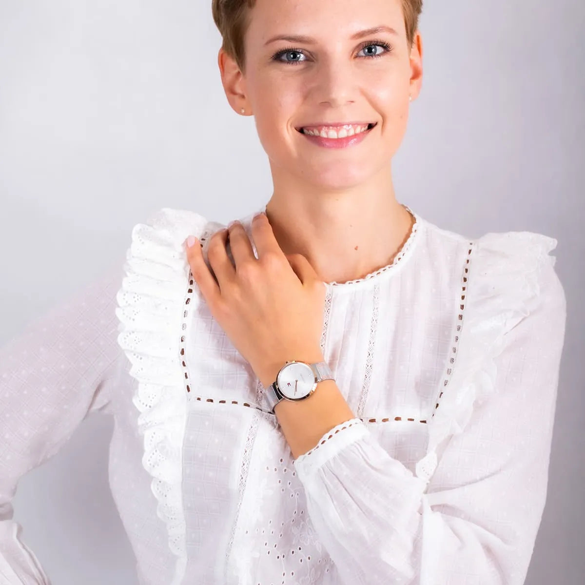 Woman wearing Tommy Hilfiger Liberty watch with white dial and crystal accents