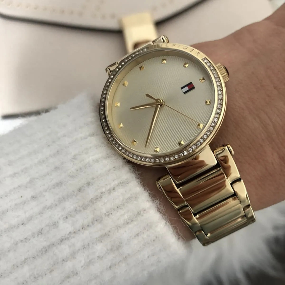 Tommy Hilfiger Lynn gold watch worn on wrist with champagne dial