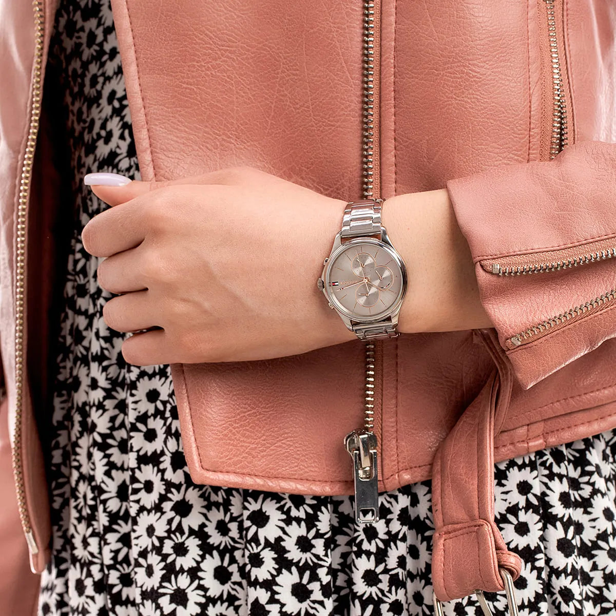 Tommy Hilfiger Skylar watch on wrist with pink jacket, displaying dial and bracelet