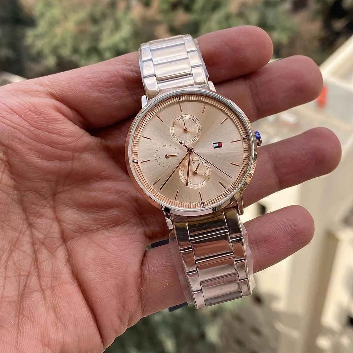 Close-up detail of rose gold Tommy Hilfiger women's watch dial with chronograph subdials