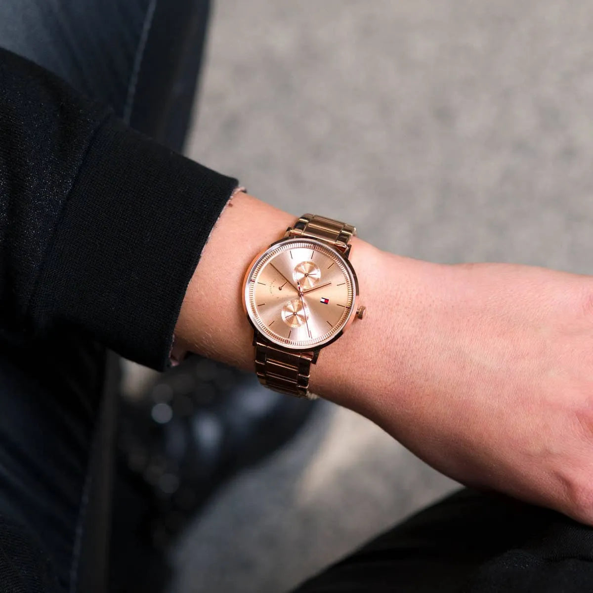 Tommy Hilfiger rose gold women's watch worn on wrist showing multifunction chronograph dial